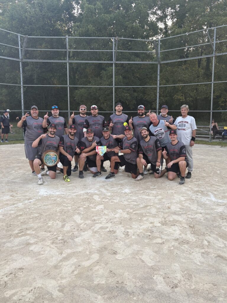 South Lyon Hotel softball team celebrates championship with trophy